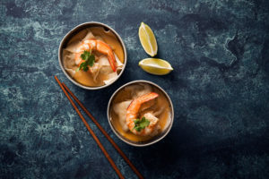 Prawn Dumplings in a Light Red Curry Sauce with Fresh Coriander in two bowls